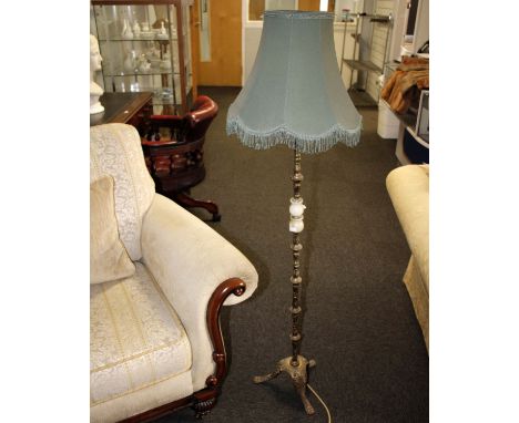 A cast brass floor lamp on tripod base with green fabric shade. Lamp stem 117cm (H) with shade 140cm (H)