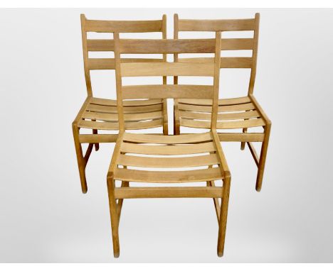 Three 20th century oak framed ladder backed chairs 