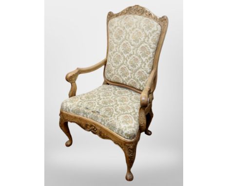 A 19th century Danish heavily carved beech armchair in tapestry upholstery 