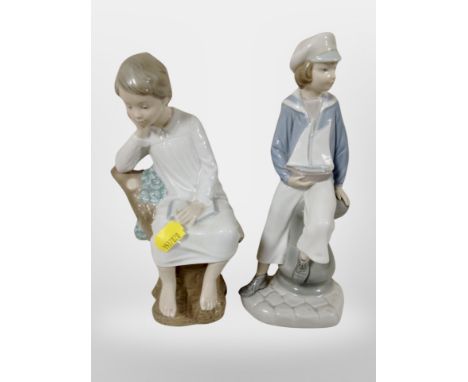 A Lladro figure of a boy dressed as a sailor, and a further boy sitting on a tree stump.