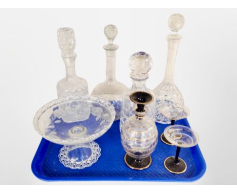 A group of crystal decanters, a gilt spiral twist decanter and pair of matching cocktail glasses, and an etched pedestal frui