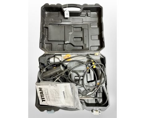 A Titan rotary hammer drill in case 