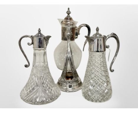 Two glass claret jugs with silver plated mounts together with a further glass decanter on stand. (3)