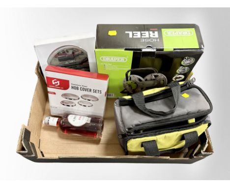 A box of new retail stock items - Bottle of pink port, Ryobi tool in bag, boxed Draper hose reel etc 