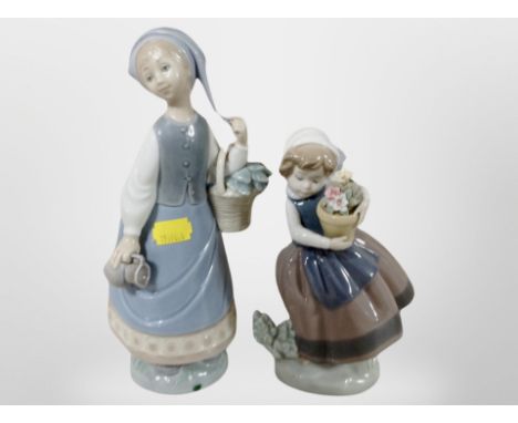Two Lladro figures of girls carrying flowers.