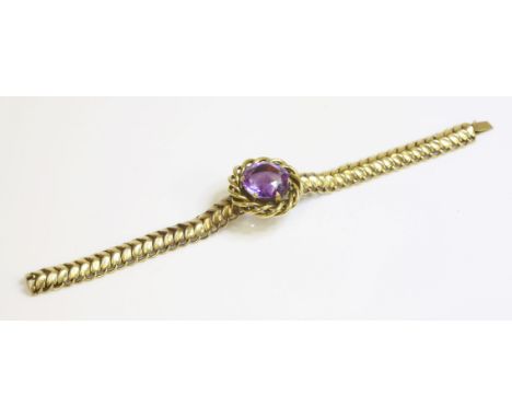 A Victorian amethyst and gold bracelet,with a centrepiece composed of a circular mixed cut amethyst, claw set to a tubular tw