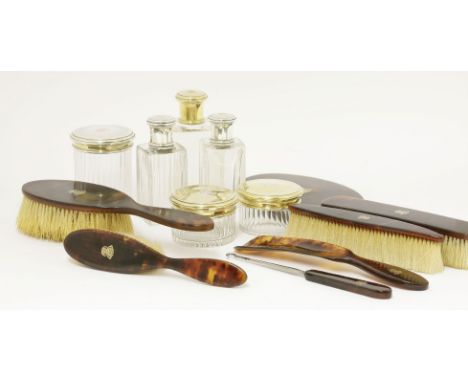 A French tortoiseshell and silver gilt dressing table set, by Gustav Keller, early 20th century, comprising three glass bottl