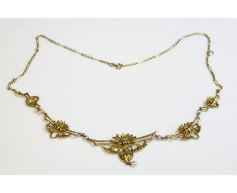 A French Art Nouveau gold and pearl necklace,with a centrepiece of graduated open panels.  The central openwork panel with a 
