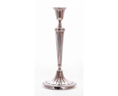 A George III silver candlestick,by John Parsons & Co., Sheffield 1784,of fluted baluster form, decorated with rosettes and be