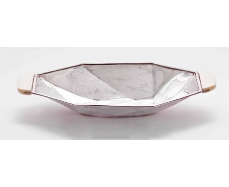 An Art Deco silver two handled dish,by Viners Ltd., Sheffield 1939,of oval angled panel form, with ivory handles,19cm wide