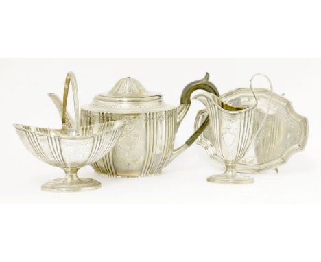 A Victorian silver three-piece tea set, maker's mark J.B unidentified, London 1882,of oval form with fluted bands and foliate