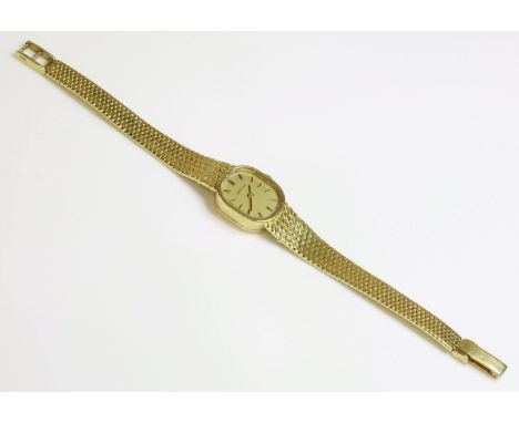 A ladies' 18ct gold Zenith mechanical bracelet watch,with an oval champagne dial, raised gilt and black batons with black han