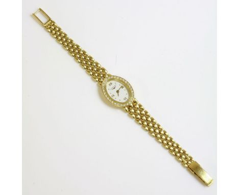 A ladies' 18ct gold Longines quartz diamond set bracelet watch,oval white dial with raised dot batons, Roman numerals at the 