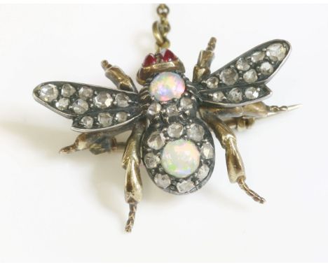 An Edwardian opal and diamond bee brooch,with cabochon ruby eyes, the thorax composed of a circular cabochon opal with rose c