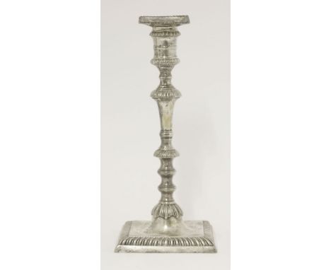 A George III silver candlestick,by Ebenezer Coker, London 1762,the faceted knopped baluster stem on square base with gadroon 