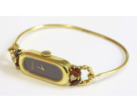 A ladies' 9ct gold Roy King mechanical bangle watch, c.1980,a baguette shaped case and burgundy lacquered dial with rounded e
