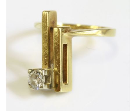 A single stone diamond ring, c.1970,with a brilliant cut diamond, claw set to a square white collet.  The collet mounted to a