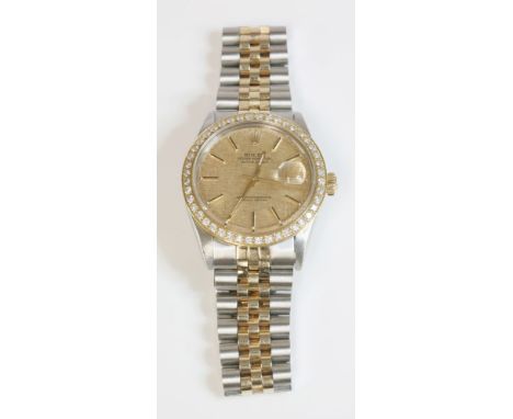 A gentlemen's bicolour Rolex Oyster Perpetual Datejust watch, c.1976,with an after market diamond set bezel and possible afte