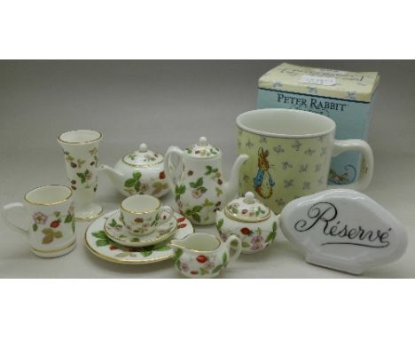 A Wedgwood miniature bone china tea set, a Peter Rabbit mug and a Reserve China plaque