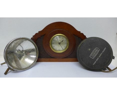 A carved mahogany mantel clock and a pair of Lucas Sealed Beam spotlights and covers (3)