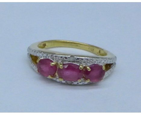 A silver gilt, ruby and diamond ring, O