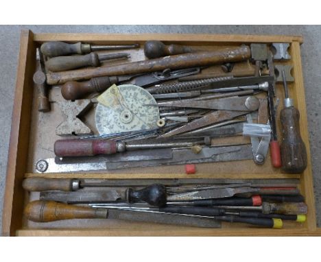 A collection of tools including a hammer, screwdrivers, files, etc.