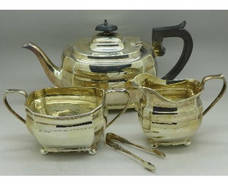 A three piece silver tea service and a pair of silver sugar bows, Sheffield 1945, 1207g, 39oz
