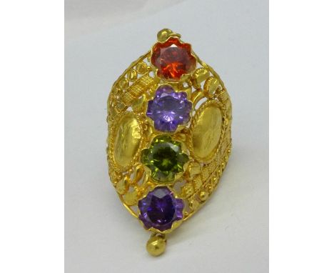 An Indian yellow metal set four stone ring, 8g, R