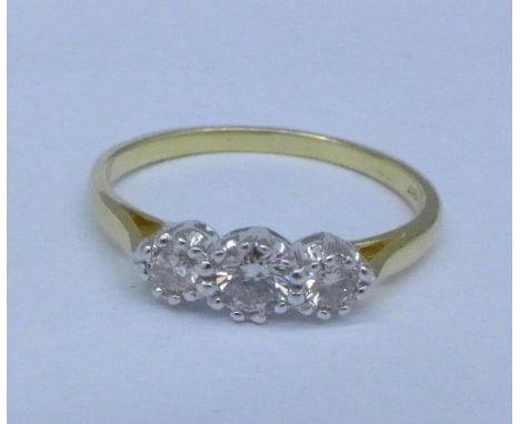 An 18ct gold, three stone, platinum set diamond ring, 2.9g, R