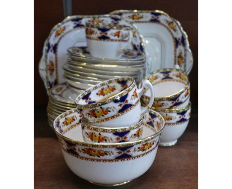 A Bradleys Salisbury tea service comprising two cake plates, twelve side plates, nine saucers, five cups and sugar, some a/f