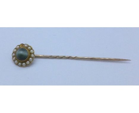 A 15ct gold stick pin, lacking one seed pearl