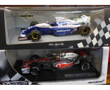 A Hot Wheels Racing and Paul's Model Art Formula 1 motor racing cars, Williams FW15 Damon Hill and MP4-22 Lewis Hamilton, box