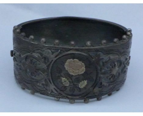 A Victorian silver bangle with gold applied decoration, Birmingham 1883, a/f