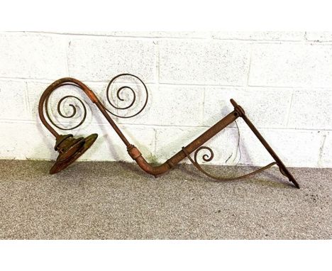 A Victorian hanging wrought iron gas lamp holder, with scrolled support, wall mounted, possibly Railway station related, 95cm