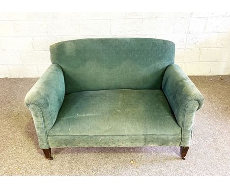 A small vintage green upholstered sofa, with curved back and scrolled arms, 130cm wide
