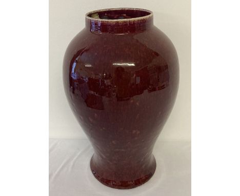 A large ceramic sang de boeuf glazed vase of bulbous form.  With central hole to underside.  Approx. 36cm tall.