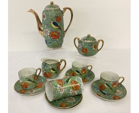 A vintage Japanese 13 piece coffee set with floral and bird detail.  Green fauna ground with hand painted flower and bird des