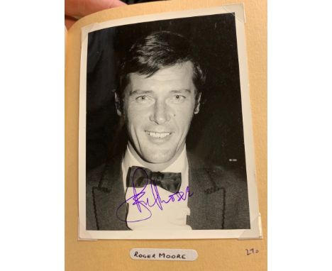 A large number of photographs presented in an album that feature personally signed autographs &amp; signatures to include Rog