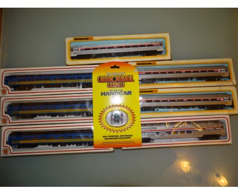 A group of American Outline coaches by BACHMANN in Amtrak, and VIA liveries together with a Cannonball Express Handcar - VG/E