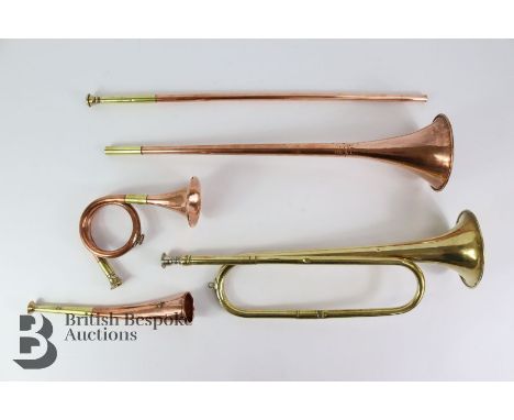 A collection of four copper and brass hunting horns, the long horn is 93cms,a shorter horn is slightly curved and is 25cms, t