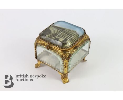 Grand Tour-style glass trinket box constructed from bevelled glass panels set within an orolu frame on all sides, raised on s