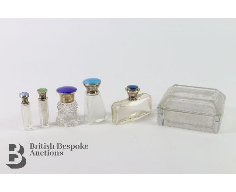 Five silver collared scent bottles: four enamel topped and one topped with a butterfly wing, together with a cut glass trinke