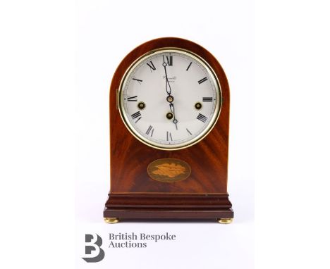 An oak Comitti London mantel clock.