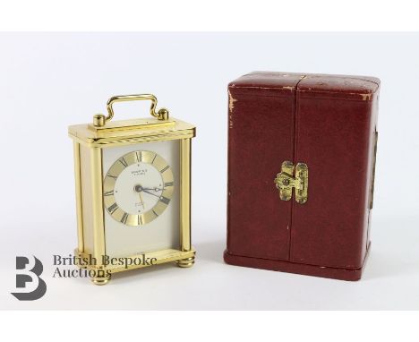 Looping miniature 8 day carriage clock in red leather box, measures approx. 8 x 6cms.