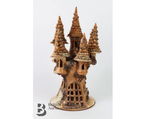 Terracotta candle lamp, in the form of a fairytale castle, approx 45 cms h, signed LA.&nbsp;