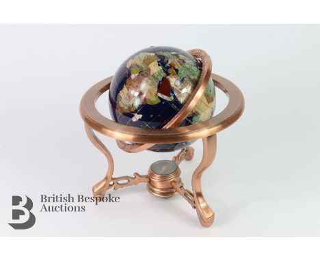 A semi precious gem stone globe with compass to base, measures approx. 27.5 cms.