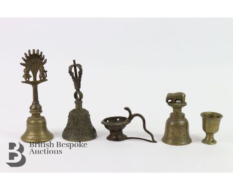 Five Tibetan prayer bells, of various heights, the first cast with birds to the finial approx 20 cms; (ii) cast with a crown 