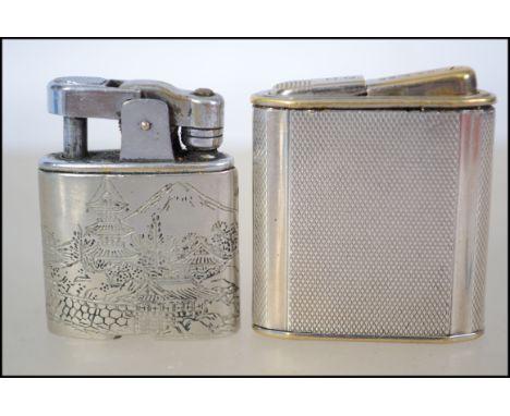 Two sterling silver cased lighters, the first having an engine turned case and the other having a Japanese village scene.
