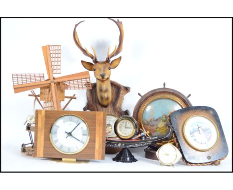 A collection of mid 20th century kitsch items to include a wall mounted deer head barometer, musical illuminated windmill, go