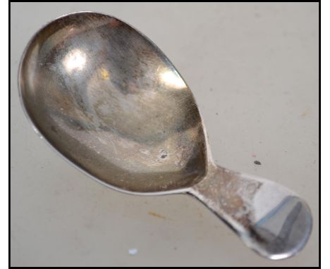 An unusual silver hallmarked caddy spoon of stub form being hallmarked possibly for James Hanna, A canadian silversmith Passa